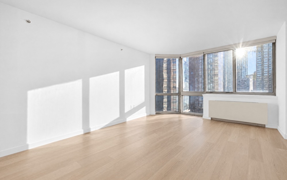 room with wood floors and white walls