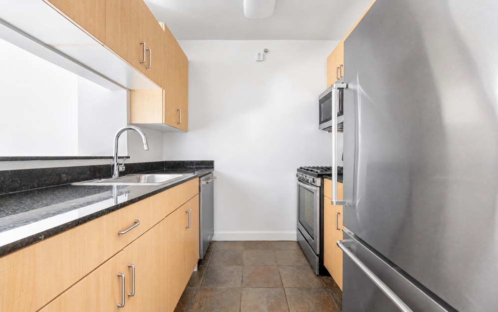 galley kitchen with stainless steel refrigerator