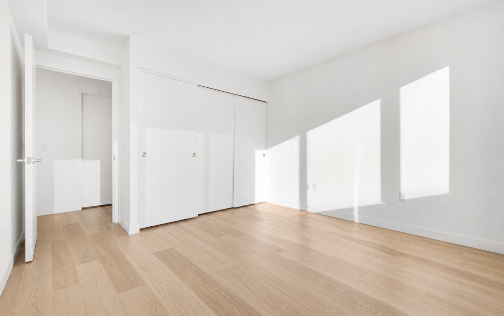 room with wood floors and white walls