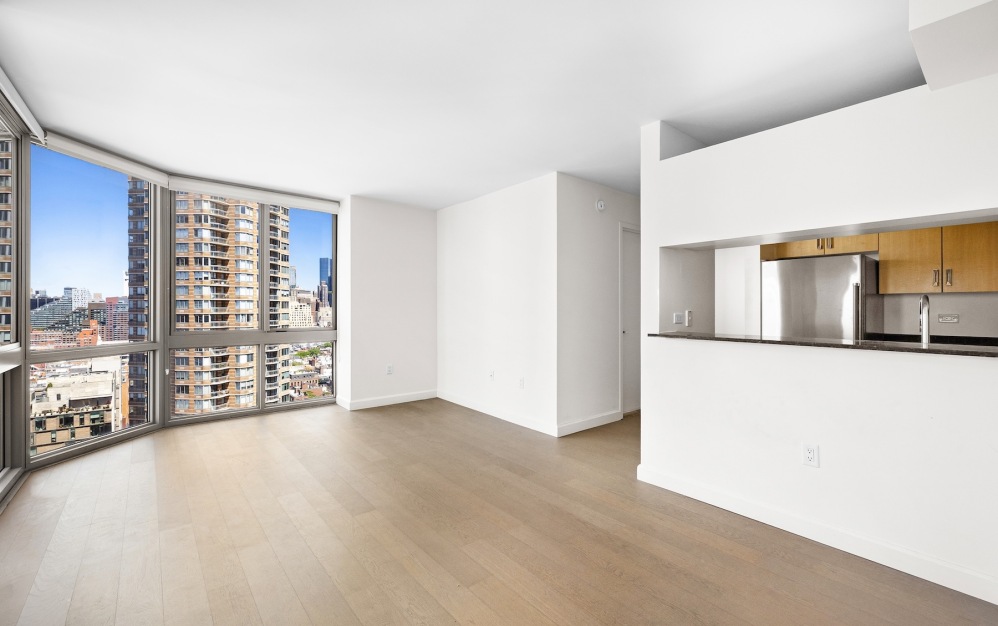 room with wood floors and kitchen