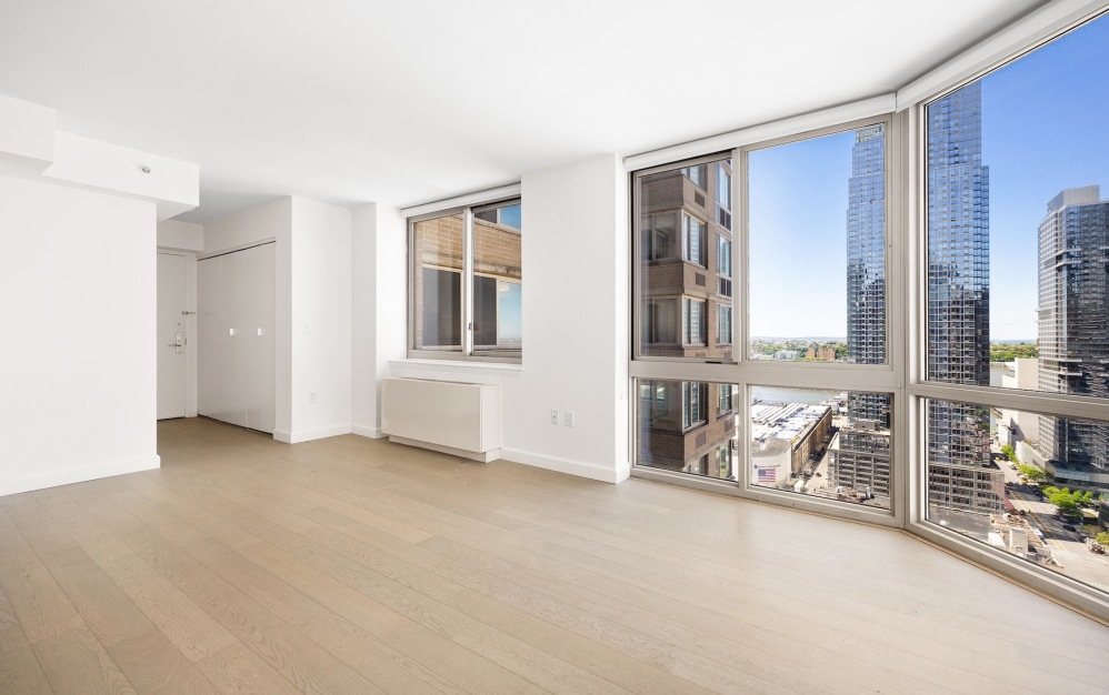 room with wood floors and large windows