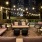 a patio with chairs and a view of a city at night