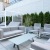 a group of white chairs and a table outside