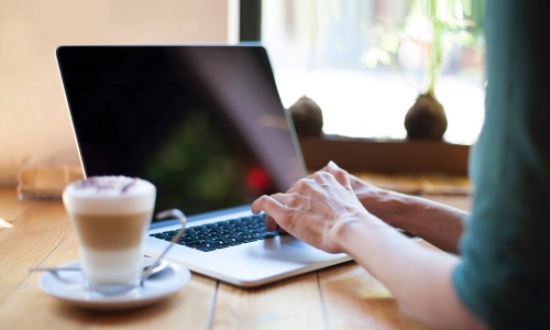 Cost-Saving Energy Reduction a woman working at a laptop